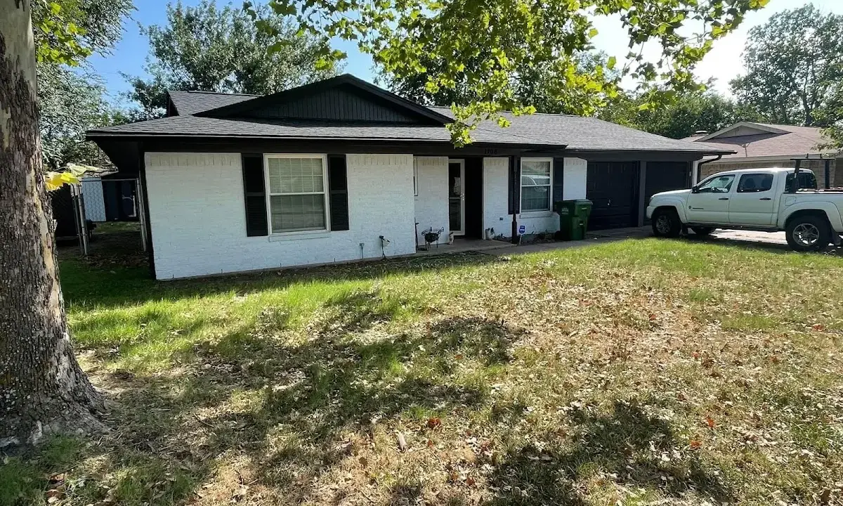 Professional roofing crew working on a residential roof in Massanetta Springs